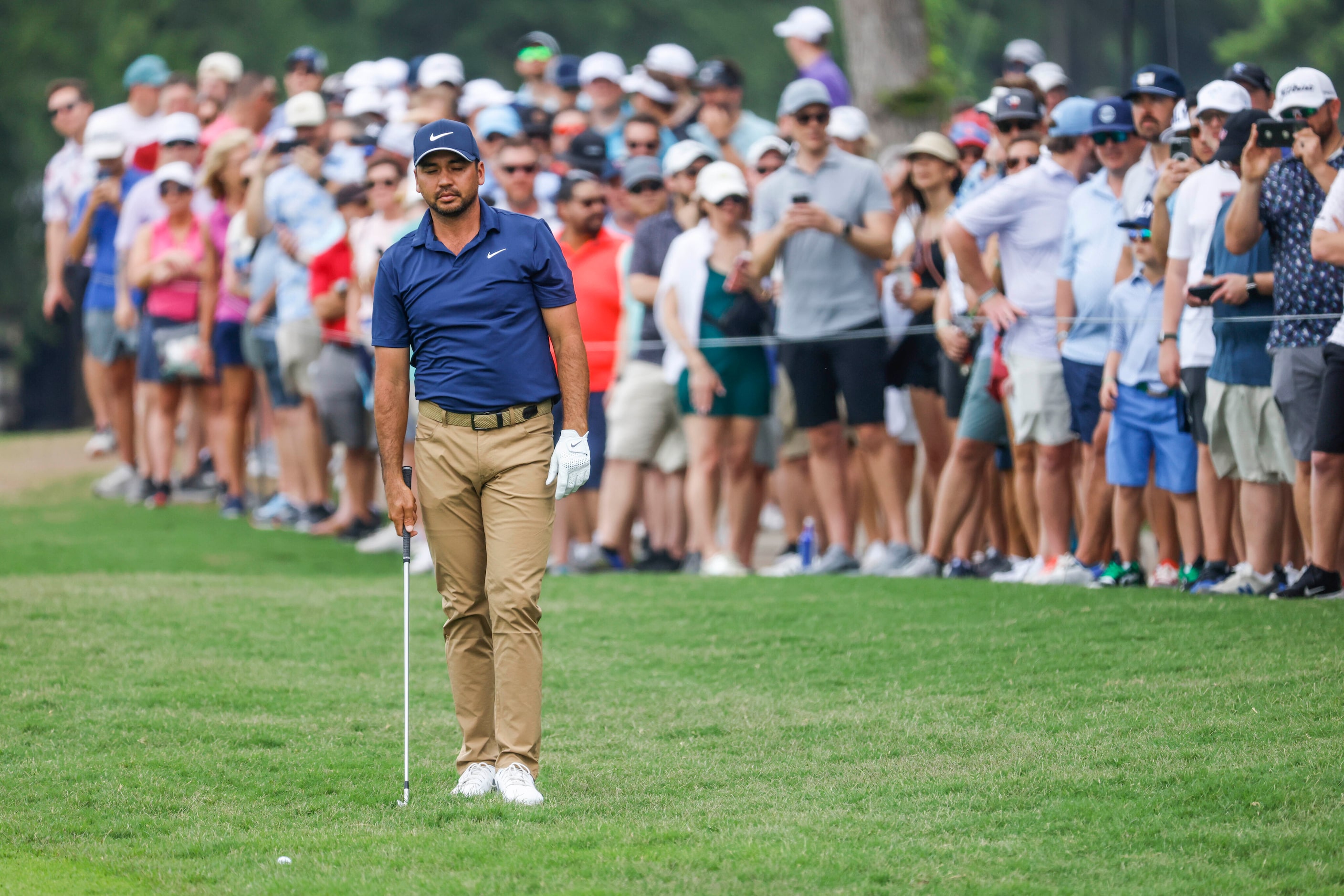 Jason Day closes his eyes before hitting on the green of the ninth hole during the second...