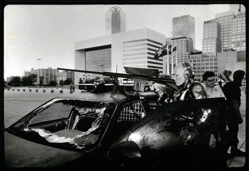 In 1987, the Dallas skyline looms behind actor Peter Weller during a filming of "RoboCop"...