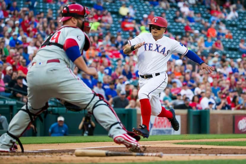 Texas Rangers designated hitter Shin-Soo Choo scores past Philadelphia Phillies catcher...