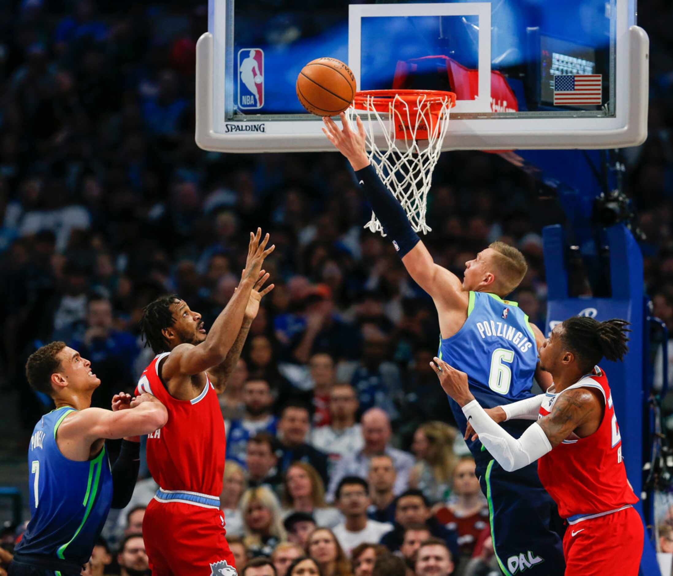Dallas Mavericks forward Kristaps Porzingis (6) goes to the basket over Sacramento Kings...