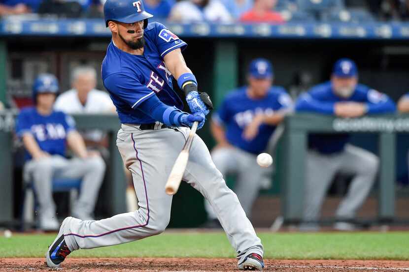 The Texas Rangers' Robinson Chirinos connects on a ground ball that turned into a fielding...