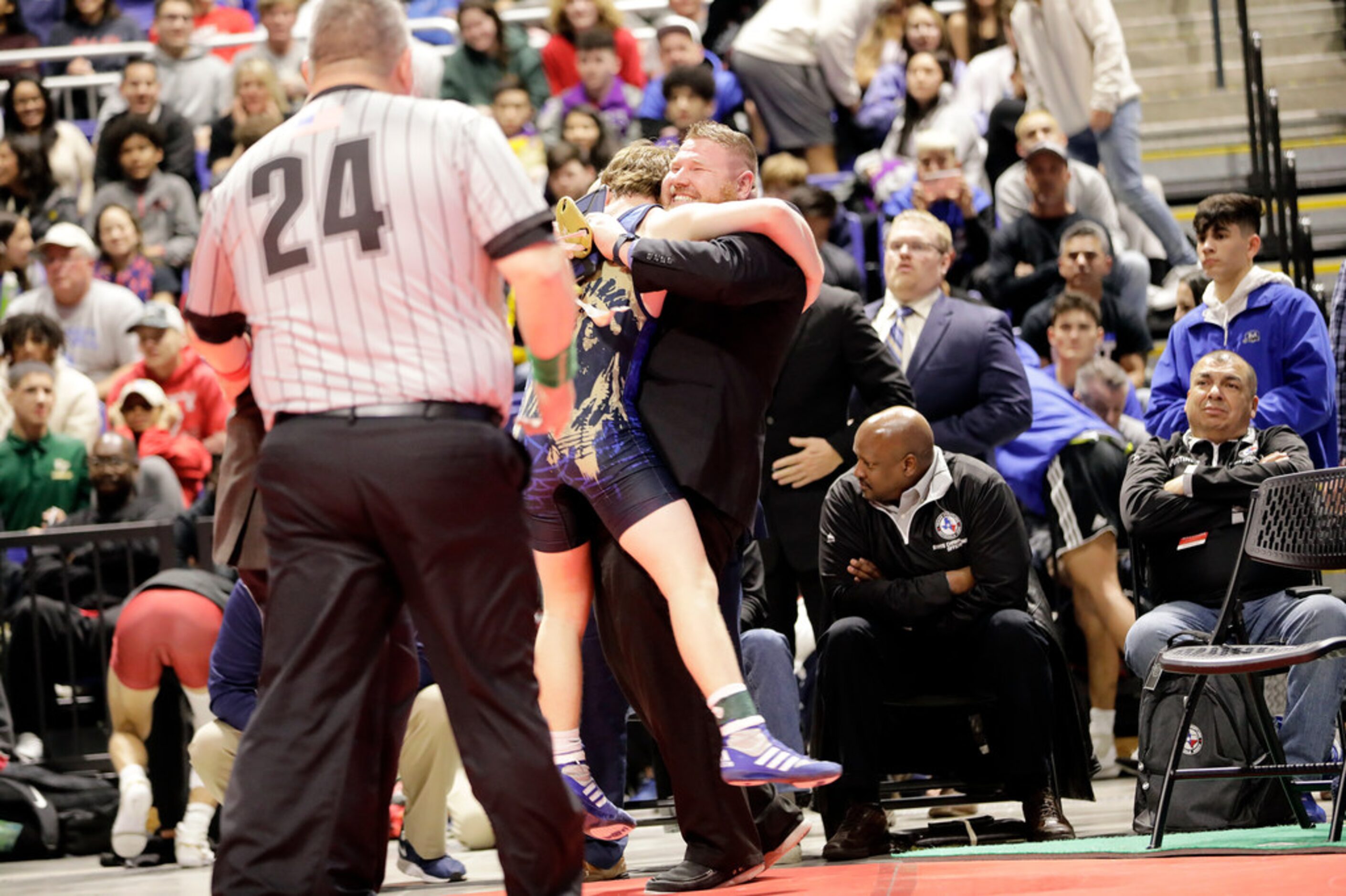 Parker Decker of Keller wrestles against Tagen Jamison of Plano West during the UIL Texas...