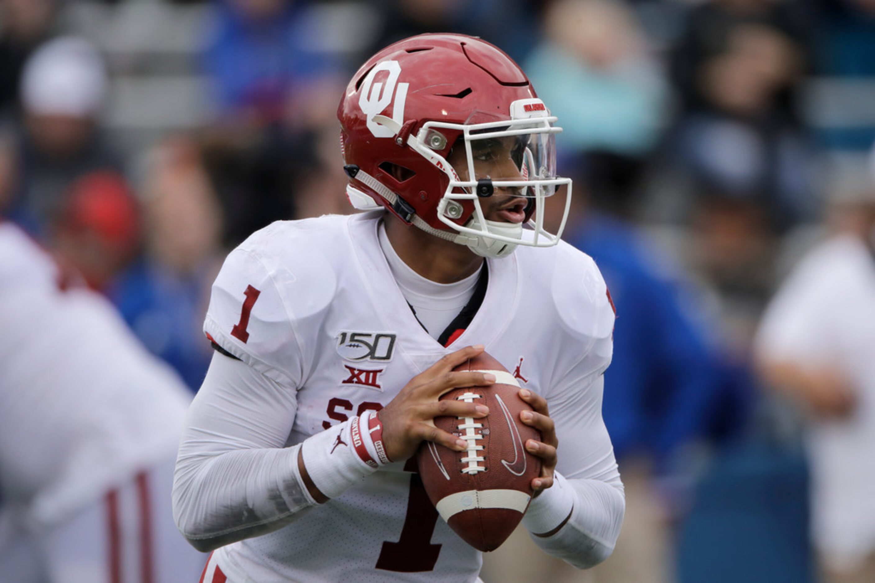 Oklahoma quarterback Jalen Hurts (1) looks for a receiver during the second half of an NCAA...