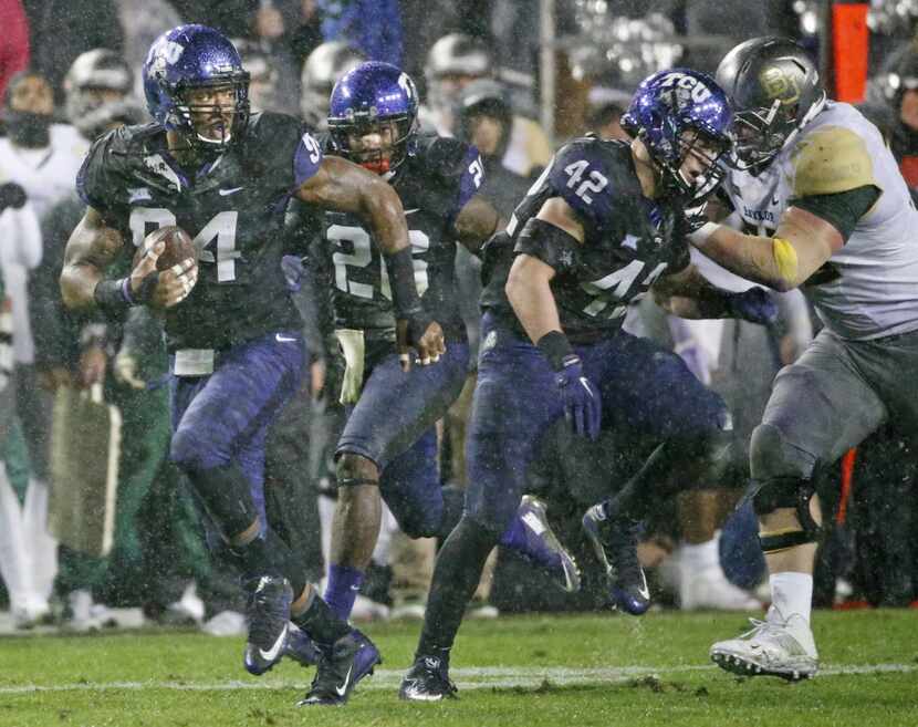 TCU Horned Frogs defensive end Josh Carraway (94) picks up a Baylor fumble and takes it to...