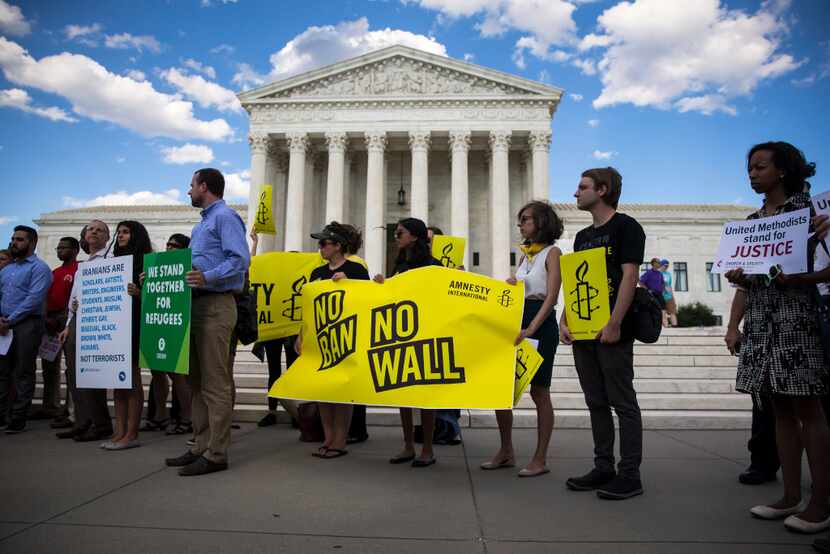 Demonstrators outside the U.S. Supreme Court on June 26, 2017, after the State Department...