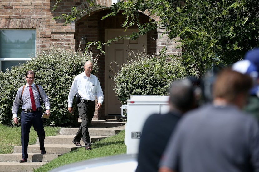 Authorities investigate Micah Johnson's home Friday morning along Helen Lane in Mesquite. A...