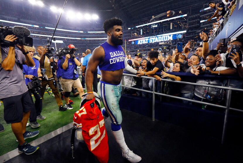 Dallas Cowboys running back Ezekiel Elliott heads for the locker room following their win...