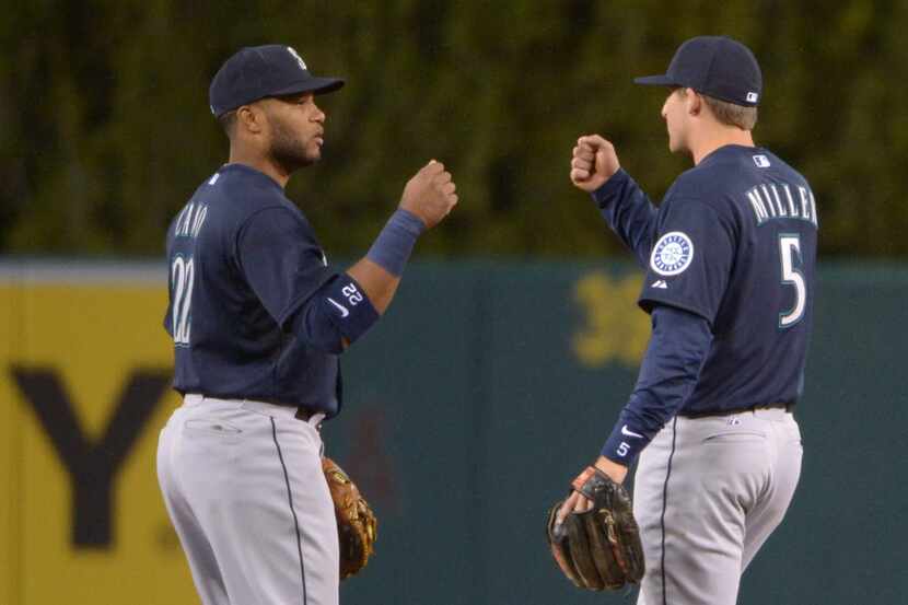 Apr 1, 2014; Anaheim, CA, USA; Seattle Mariners second baseman Robinson Cano (left) and...