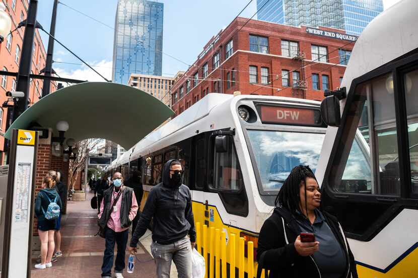 Riders enter and exit a DART train at the West End Station in downtown Dallas, in March 2022.