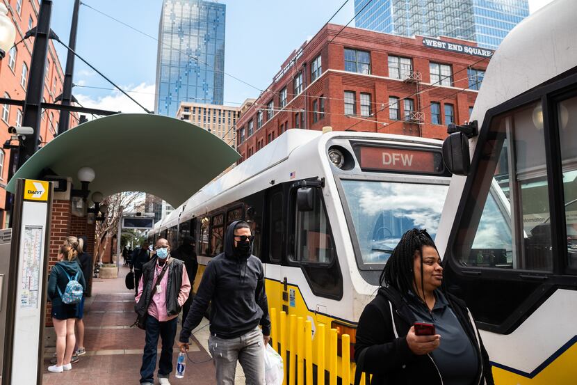 Riders enter and exit a DART train at the West End Station in downtown Dallas, on Friday,...