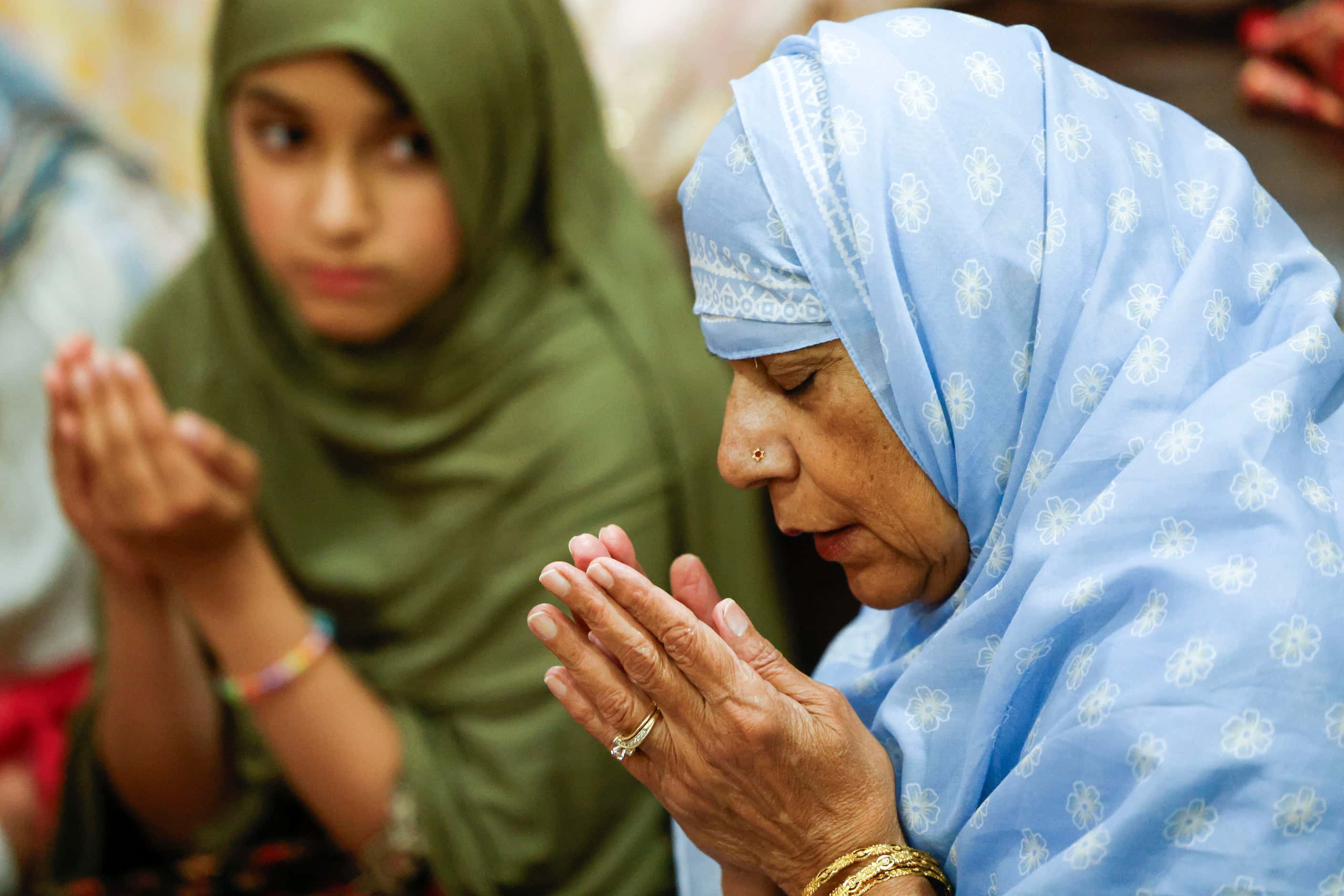 Anaya Choudhry, 8,  (left), looks over to her grandmother Navin Butt as she finishes her...