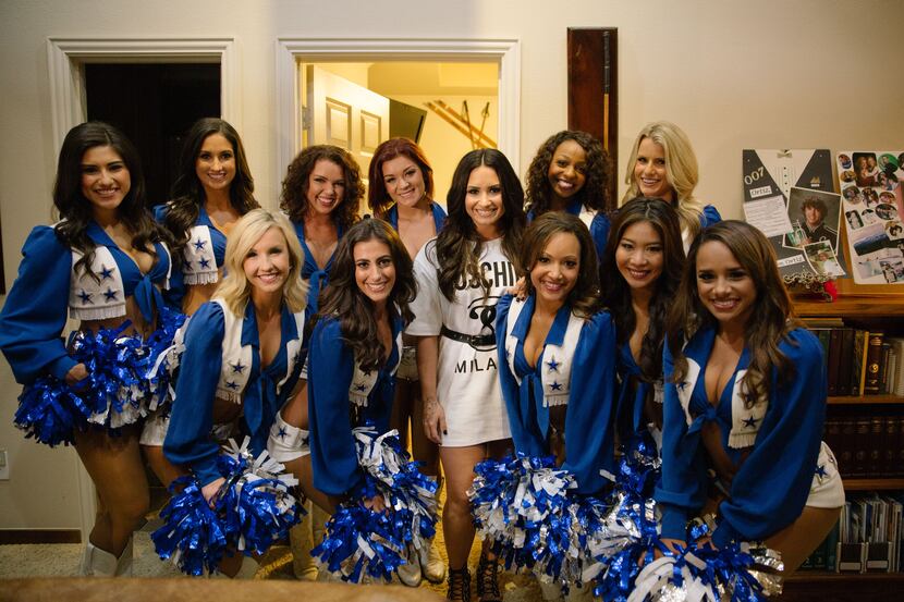 Singer and actress Demi Lovato posed with her special guests, the Dallas Cowboys...