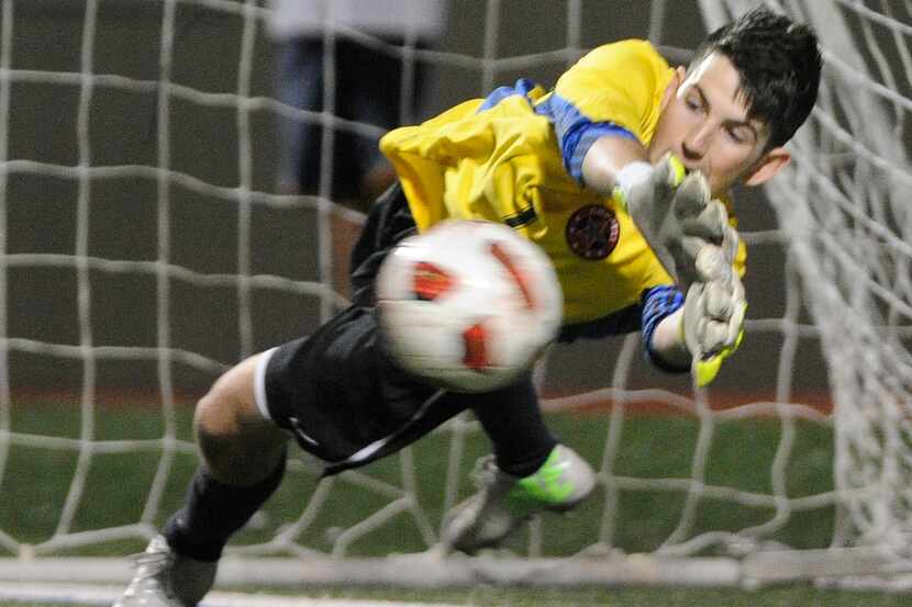 Coppell goalkeeper Dante DiCiolli makes a penalty kick save during a boys Class 5A high...