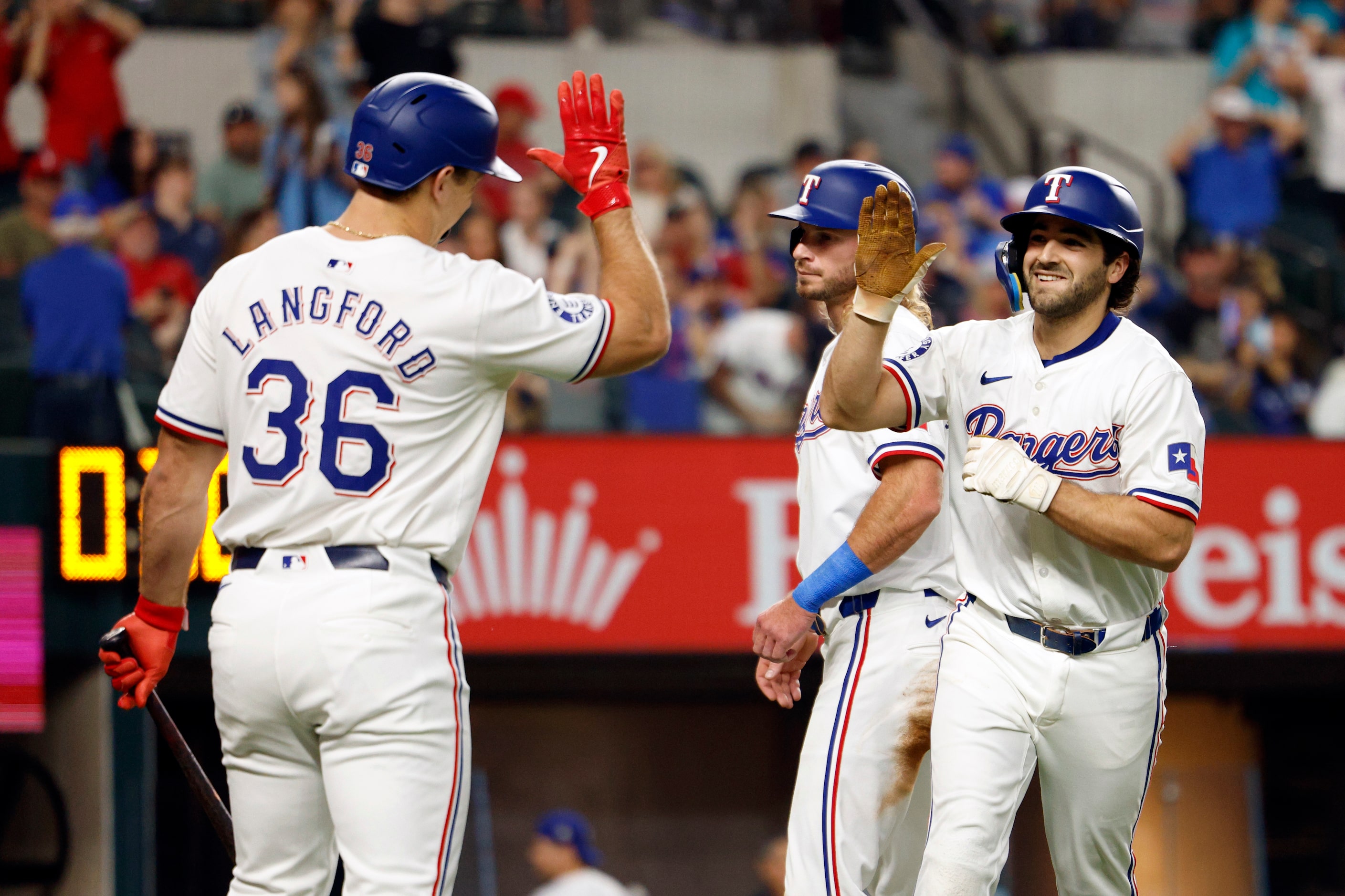 Texas Rangers shortstop Josh Smith (right) celebrates his two-run home run with left fielder...