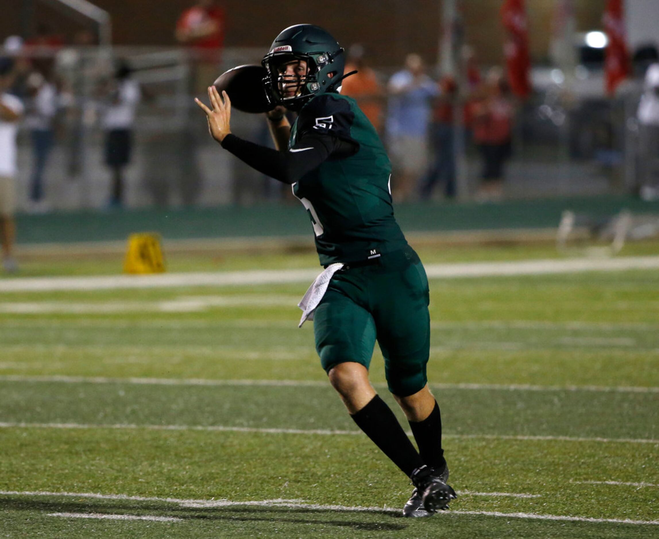 Kennedale's Seth Paroulek (5) throws a touchdown pass against Kennedale Heritage during the...