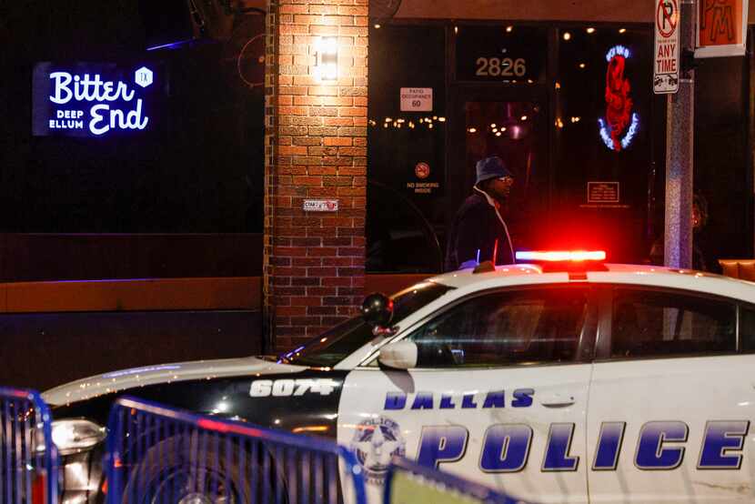 Bitter End sits empty as Dallas police patrol cars block traffic on Elm Street in Deep Ellum...