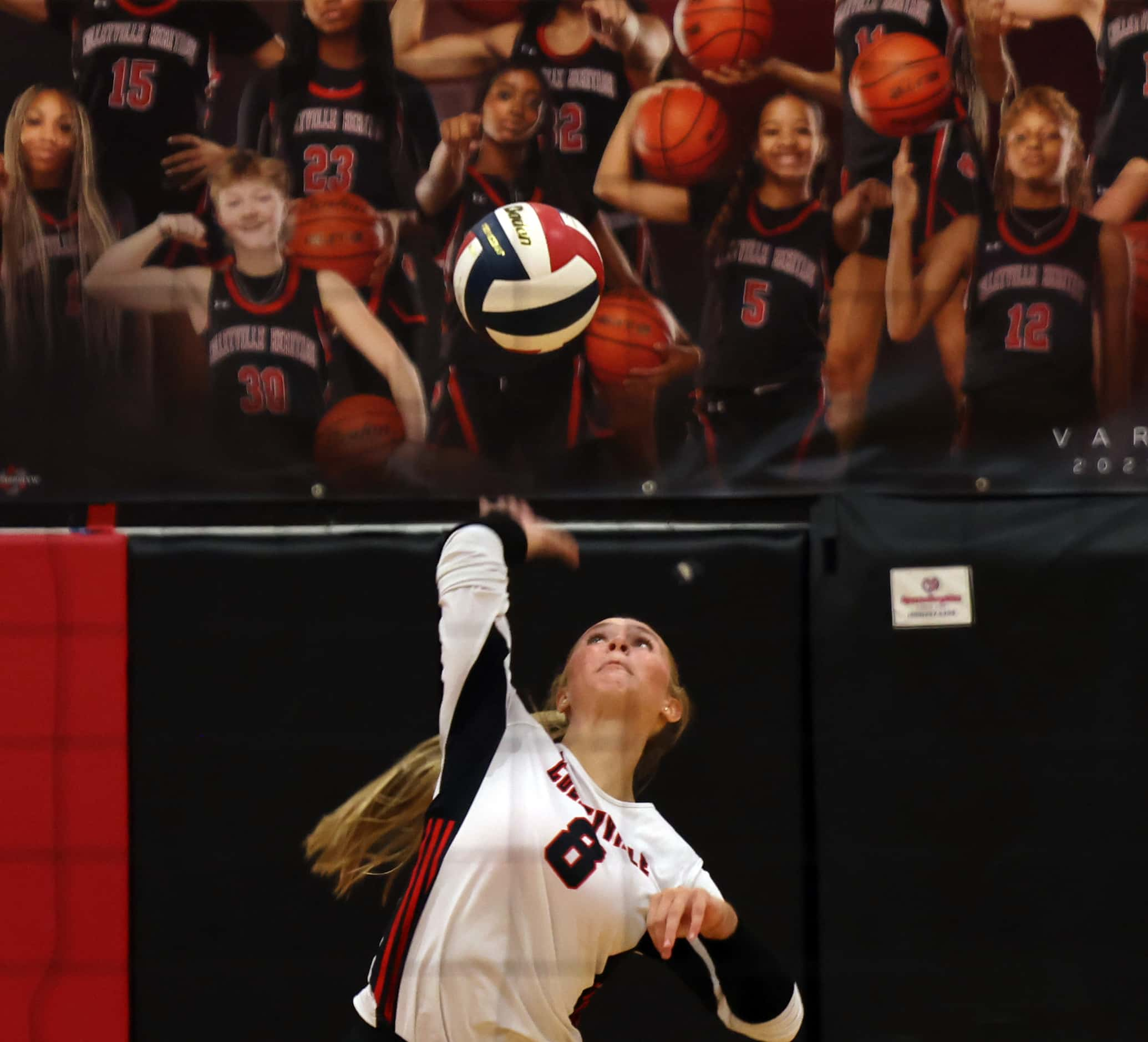 Colleyville Heritage setter Claire Bundy (8) serves during the first set of their match...