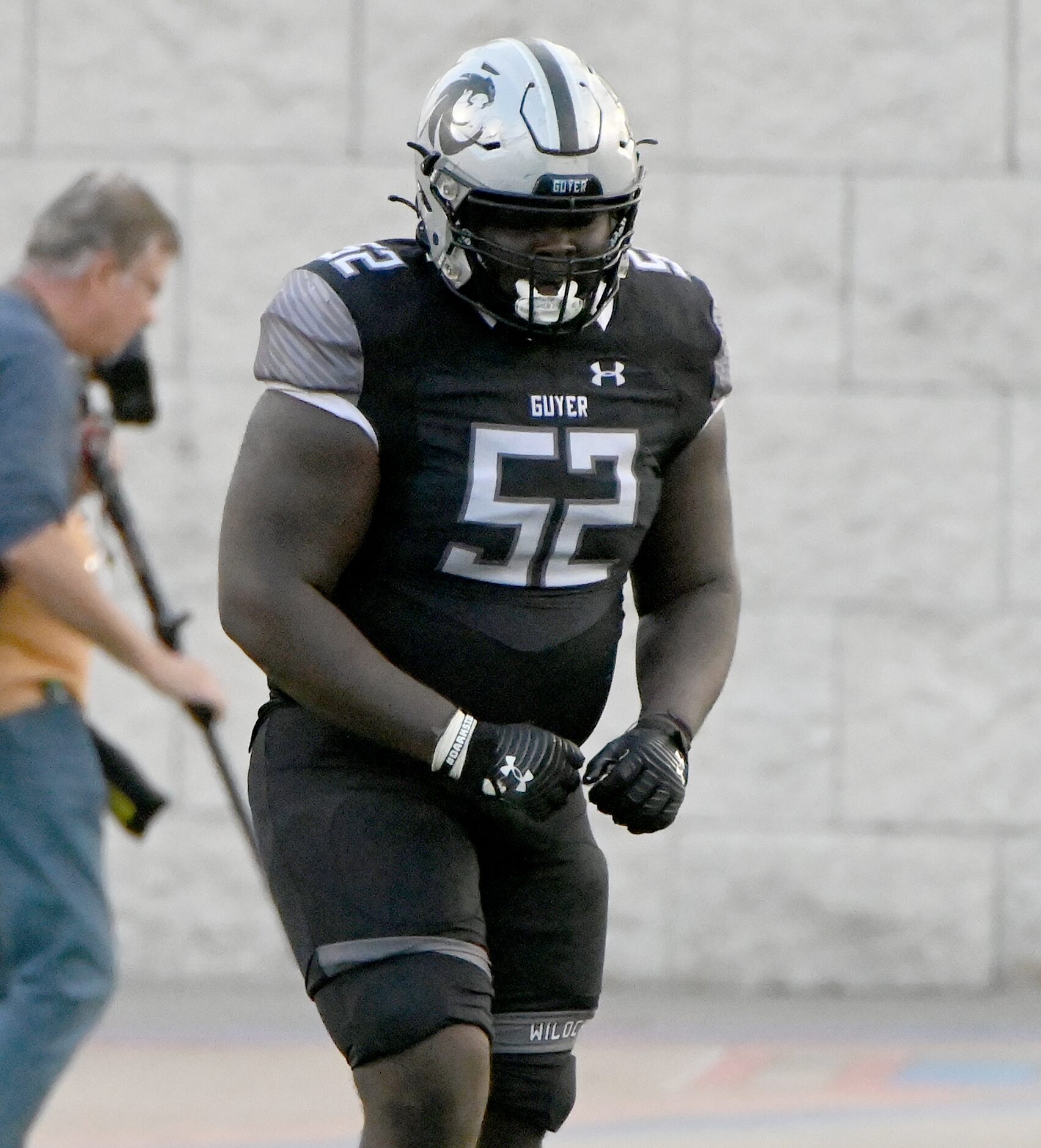 Denton Guyer's Pelumi Olanipekun (52) celebrates after a play in the second half of a Class...