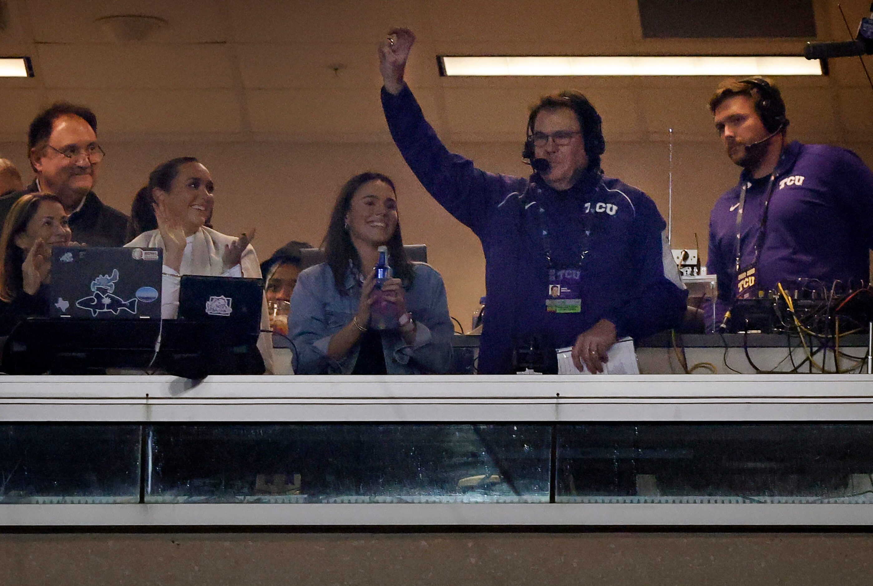 Longtime TCU Horned Frogs broadcaster John Denton (second from right) acknowledges the crowd...