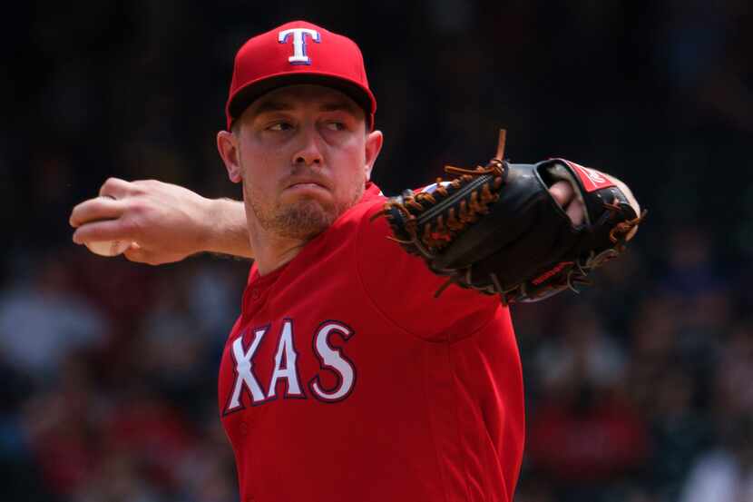 Texas Rangers pitcher Adrian Sampson pitches during the sixth inning against the Seattle...