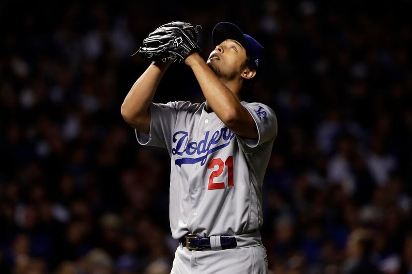 Los Angeles Dodgers starting pitcher Yu Darvish (21) looks up the sky as he exits in the...