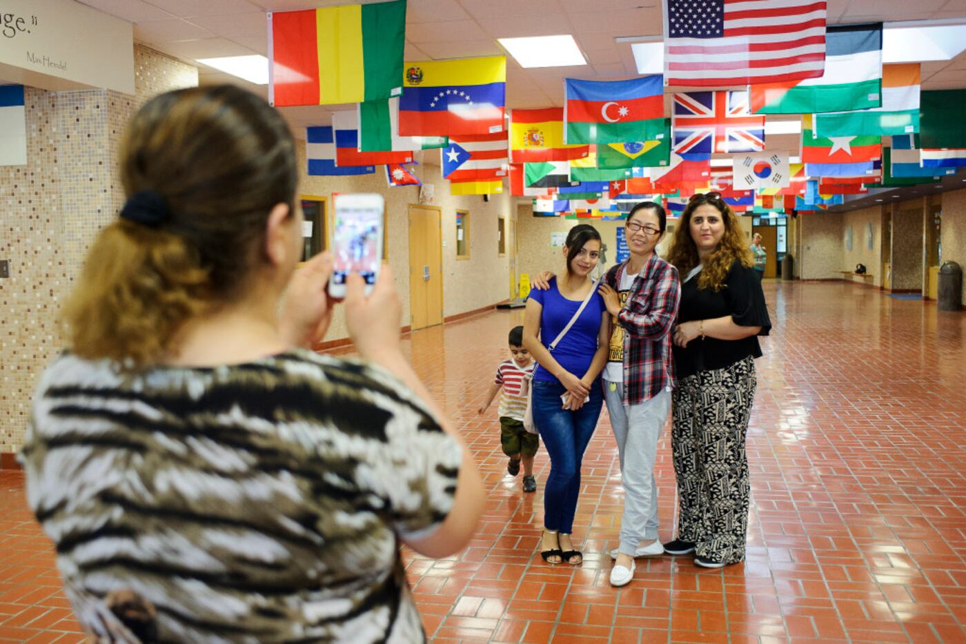 Students from Iraq, Mexico and China took pictures together after the last class of a...