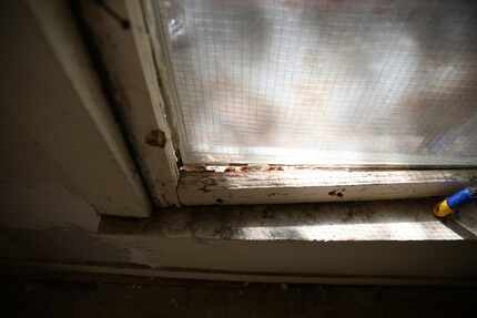 A broken window of the HMK rent house Fernando and Yolanda Gonzalez plan to move into in...