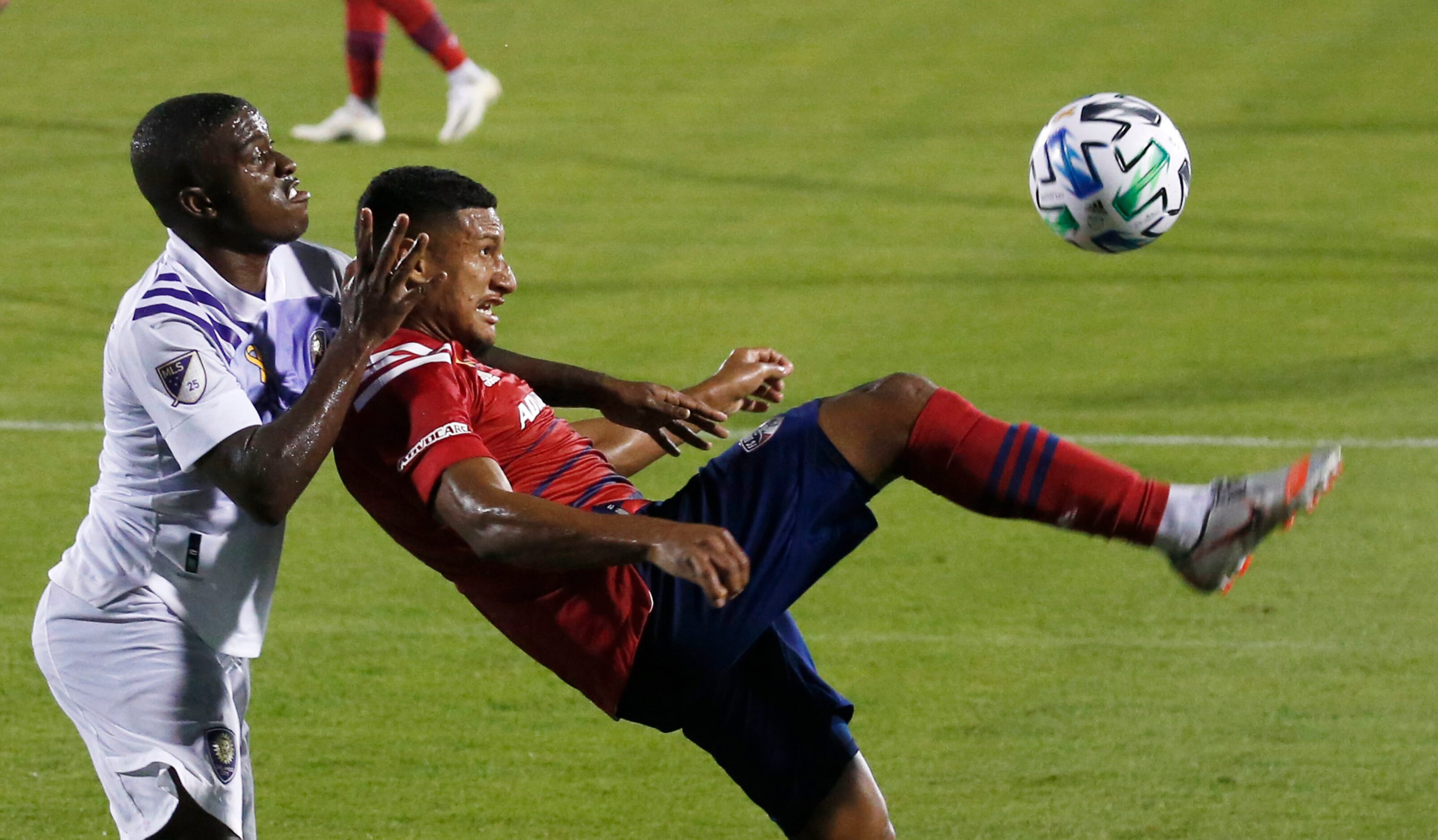 FC Dallas midfielder Bryan Acosta (8) attempts a shot in front of Orlando City midfielder...