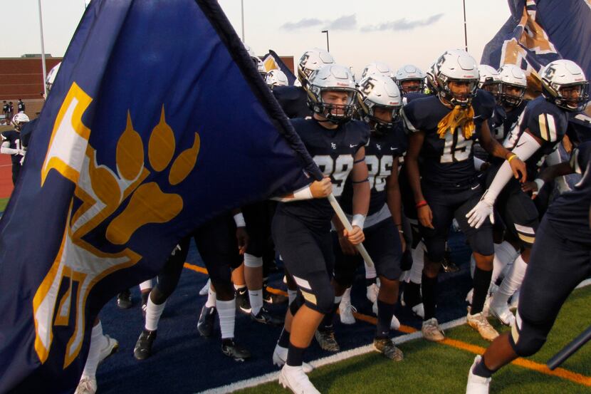 Members of the Little Elm Lobos prepare to run onto the field prior to the opening kickoff...