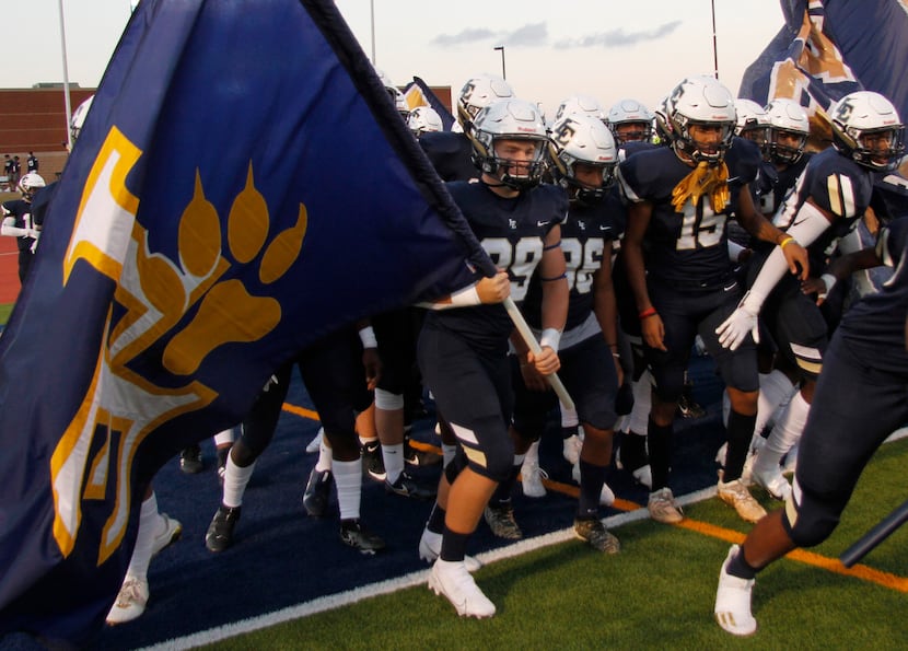 Members of the Little Elm Lobos prepare to run onto the field prior to the opening kickoff...