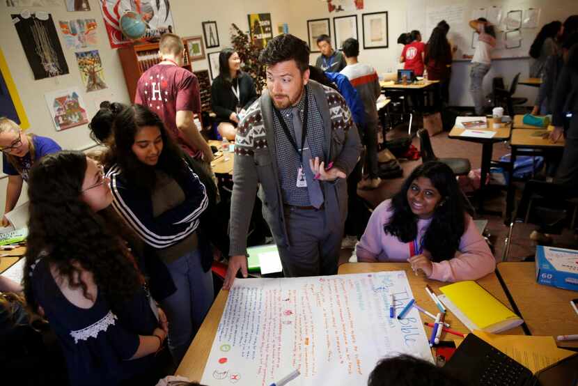 Josh Melton, AP literature teacher, talks with his students during class at Frisco ISD's...