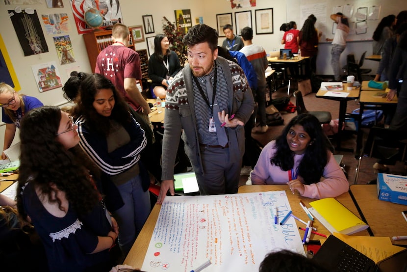 Josh Melton, AP literature teacher, talks with his students during class at Frisco ISD's...