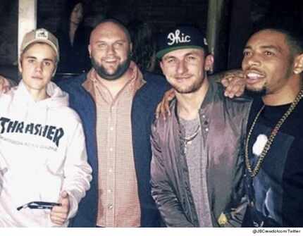  Johnny Manziel (center right) attended a Justin Bieber concert hours after a grand jury...
