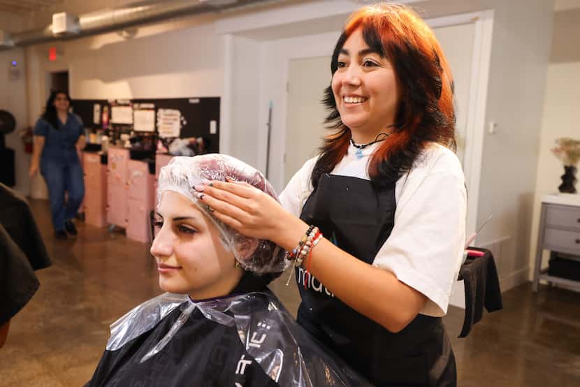 Emilia Alba wraps Sarah Hatam s hair for processing Wednesday, Oct. 25, 2023, at the Bloom...