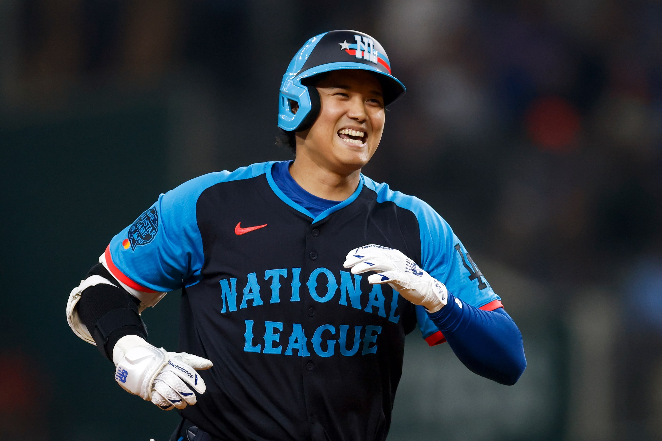 National League's Shohei Ohtani, of the Los Angeles Dodgers, celebrates after hitting a...