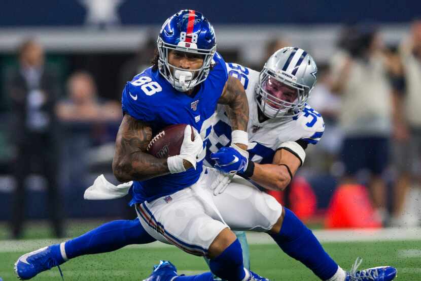 Dallas Cowboys strong safety Jeff Heath (38) tackles New York Giants tight end Evan Engram...