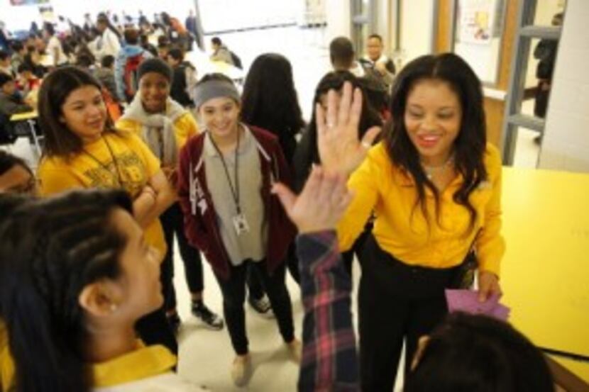  John B. Hood Middle School principal LaTonya Lockhart gave high-fives to her Student...