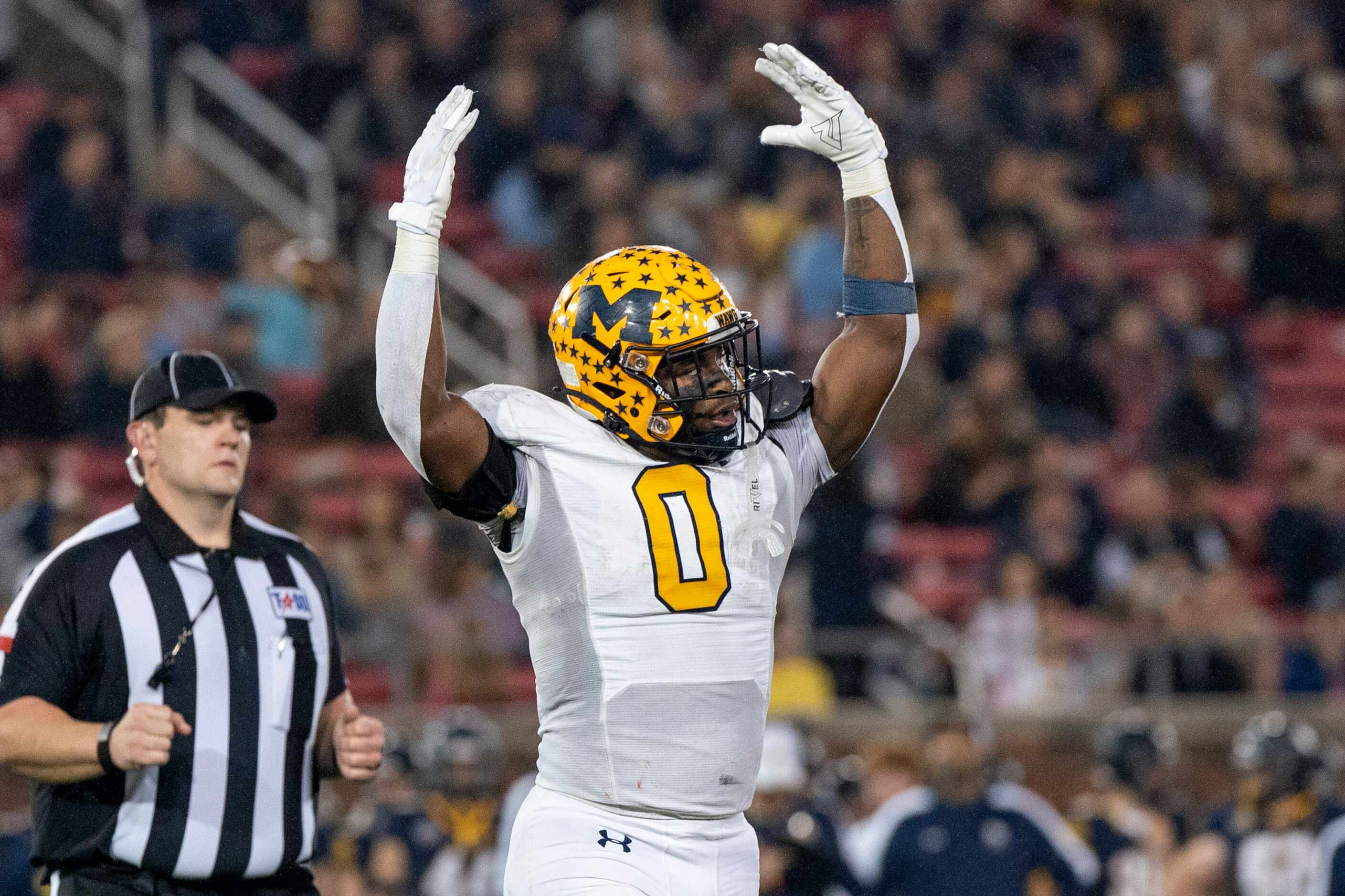 McKinney senior linebacker Makhi Frazier (0) hypes up the crowd during the first half of a...