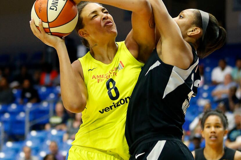 Dallas Wings center Liz Cambage (8) powers Las Vegas Aces center A'ja Wilson during the...