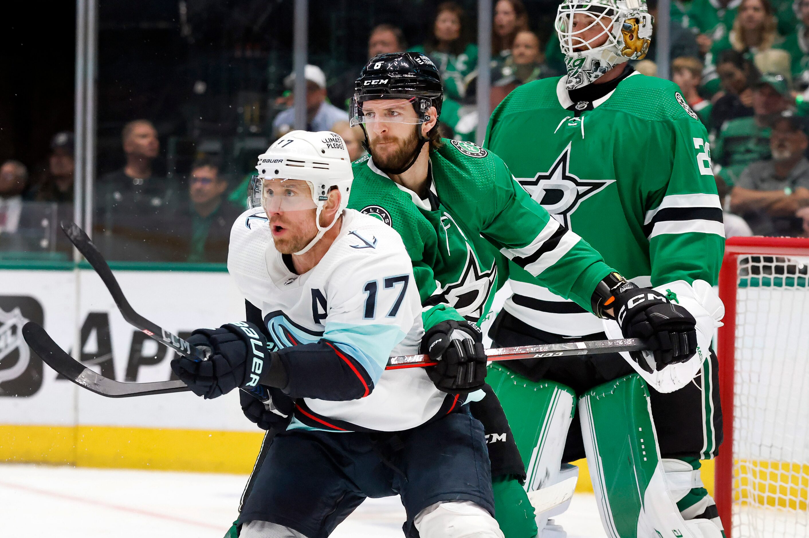 Dallas Stars defenseman Colin Miller (6) cradles Seattle Kraken center Jaden Schwartz (17)...