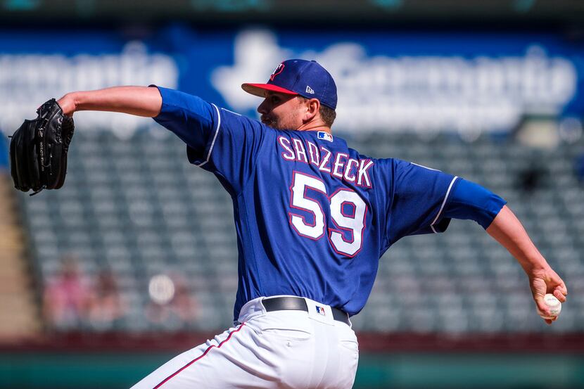 Texas Rangers pitcher Connor Sadzeck pitches during the eighth inning of a spring training...