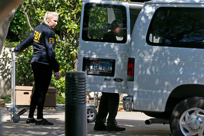FBI agents loaded boxes into a van while federal agents raided Medoc Health Services in...