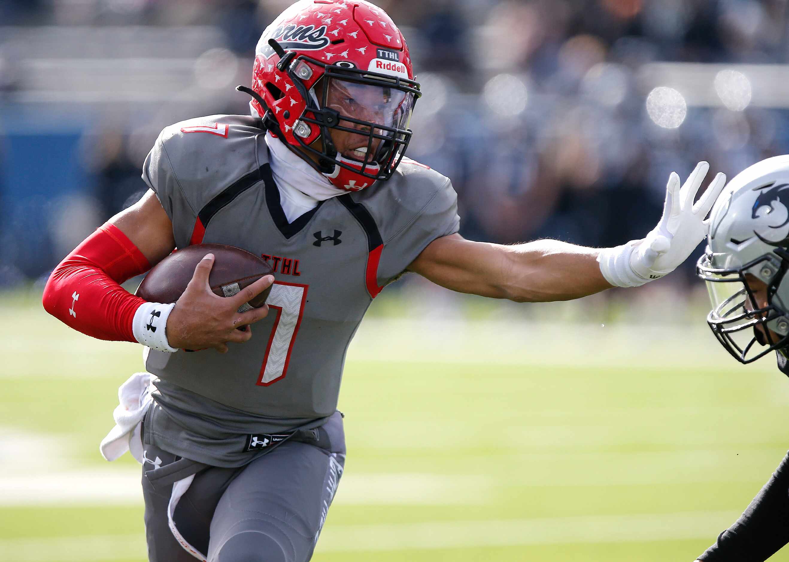 Cedar Hill High School quarterback Kaidon Salter (7) uses a stiff arm on a run during the...