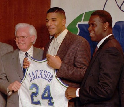 Mavericks owner Don Carter (left) poses with first-round draft pick Jim Jackson (center) and...