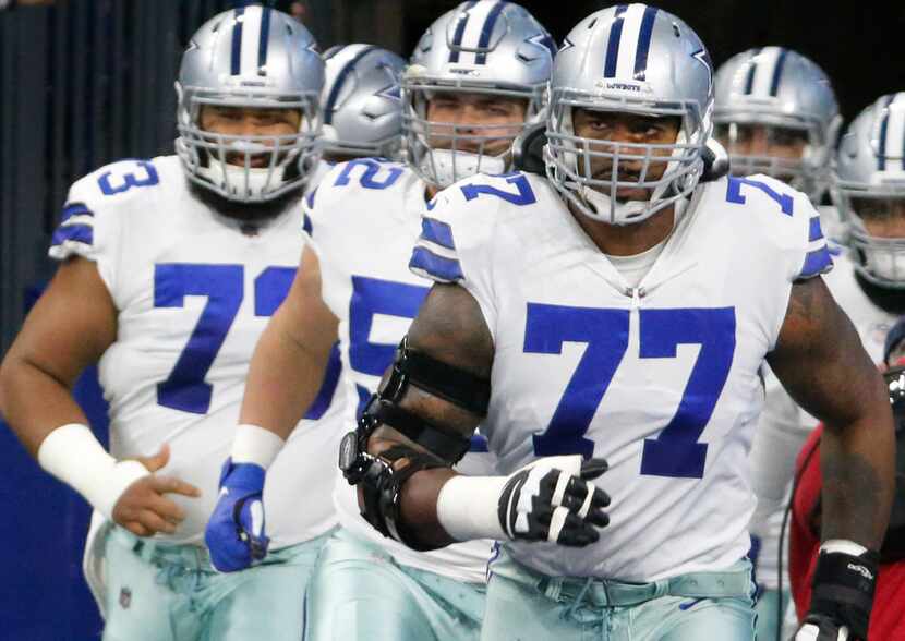 Dallas Cowboys offensive tackle Tyron Smith (77) is pictured with teammates during the...