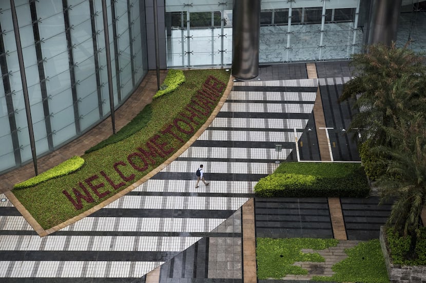 A garden with 'Welcome to Huawei' spelled out in flowers is seen outside an office building ...