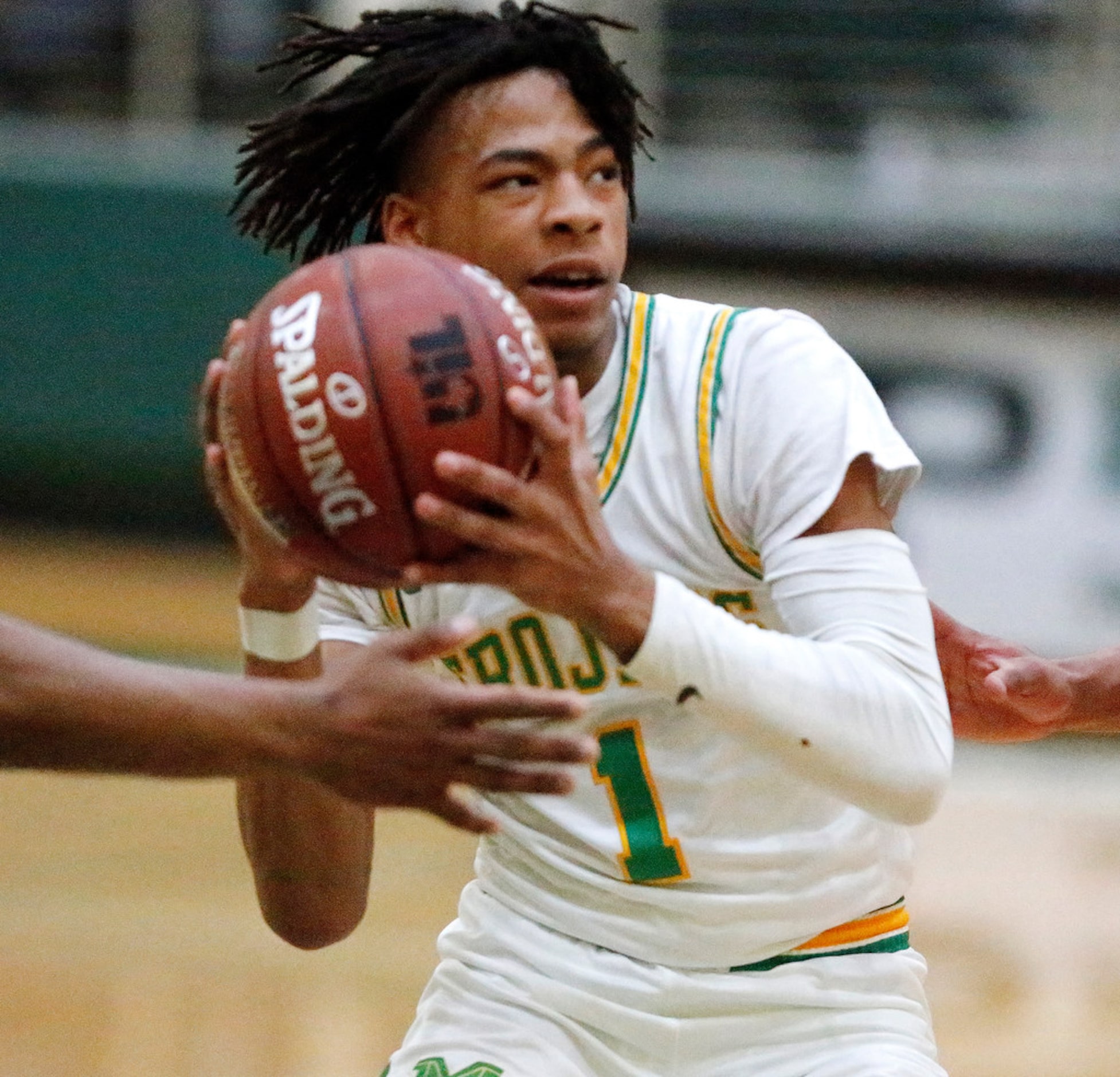 Madison High School guard Pierre Hunter (1) drives to the basket during the first half as...