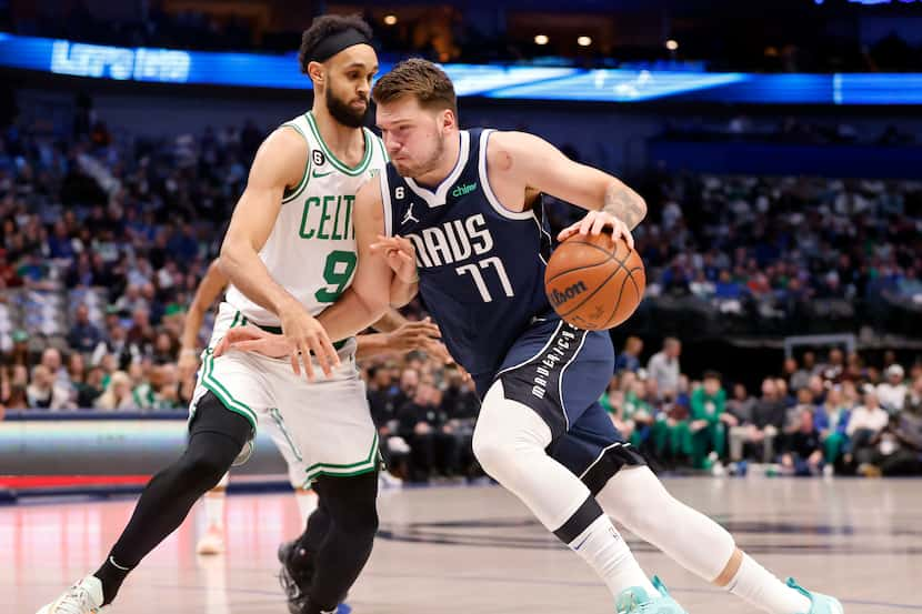 Dallas Mavericks guard Luka Doncic (77) dribbles around Boston Celtics guard Derrick White...