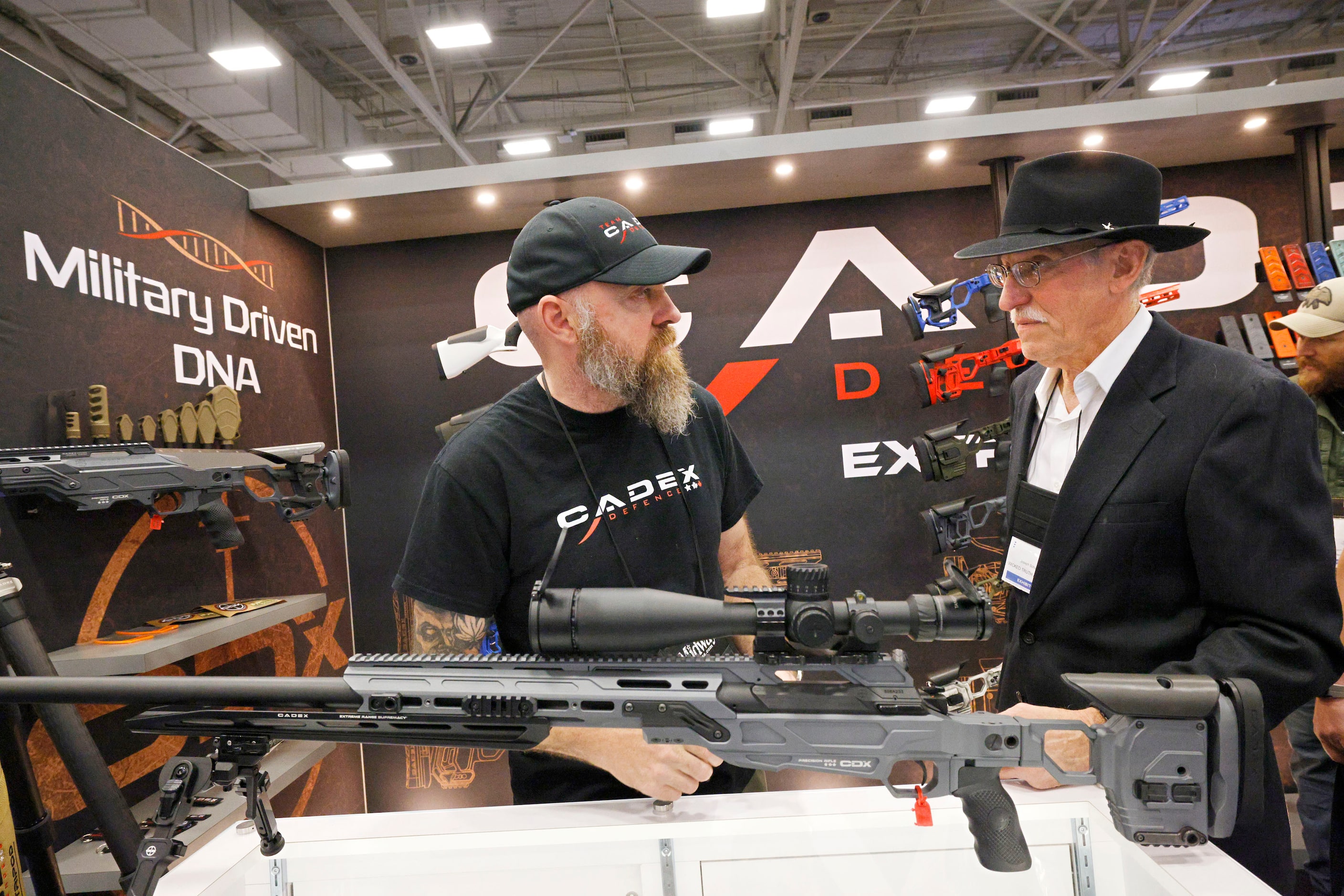 Jamie Barkwell of Codex Defense, left, talks with Joseph Schuster of Pittsburgh in front of...