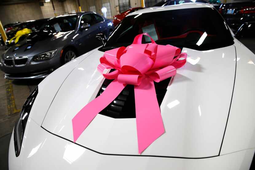 Every car sold by Beepi is delivered to its new owner with a ribbon on the hood.  (File...